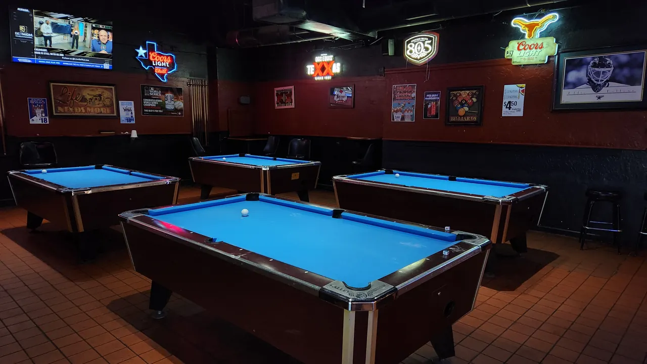 Blue-felt pool tables with sports TVs at Sparks Sports Bar